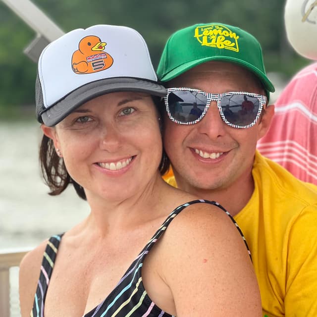 Sarah and Jeff Hanson smiling in front of a scenic background.